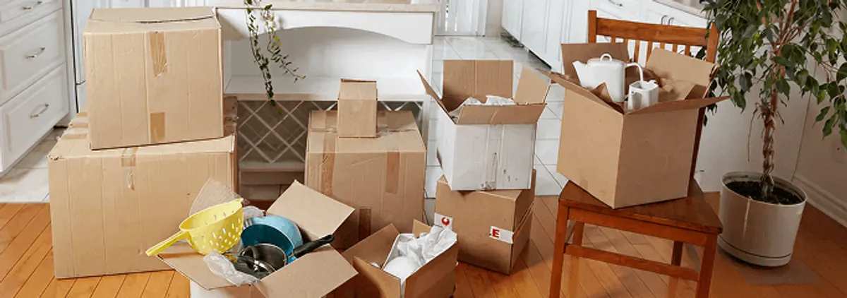 Packed moving boxes and household items in a kitchen before move-out or move-in cleaning, Phoenix, AZ.